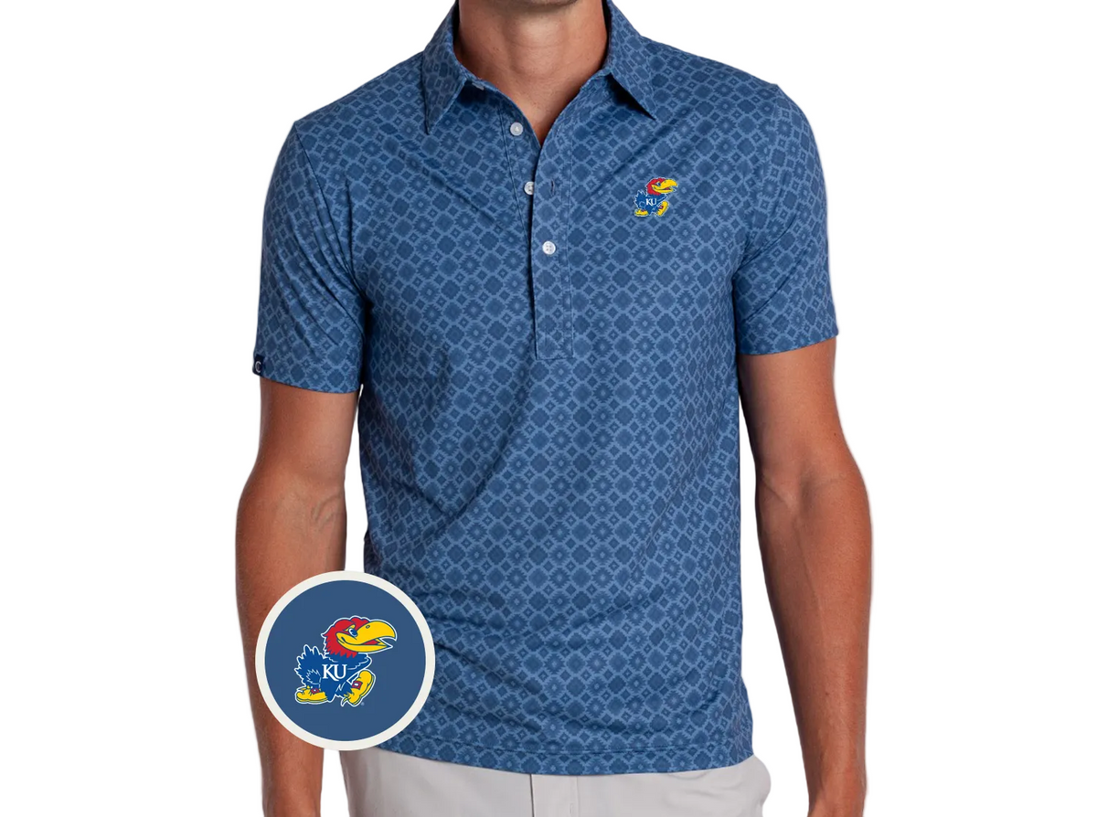 A man wearing a blue short-sleeve polo shirt with a repeating geometric pattern and a small Kansas Jayhawks logo on the left chest. A circular inset shows a close-up of the Jayhawks logo.