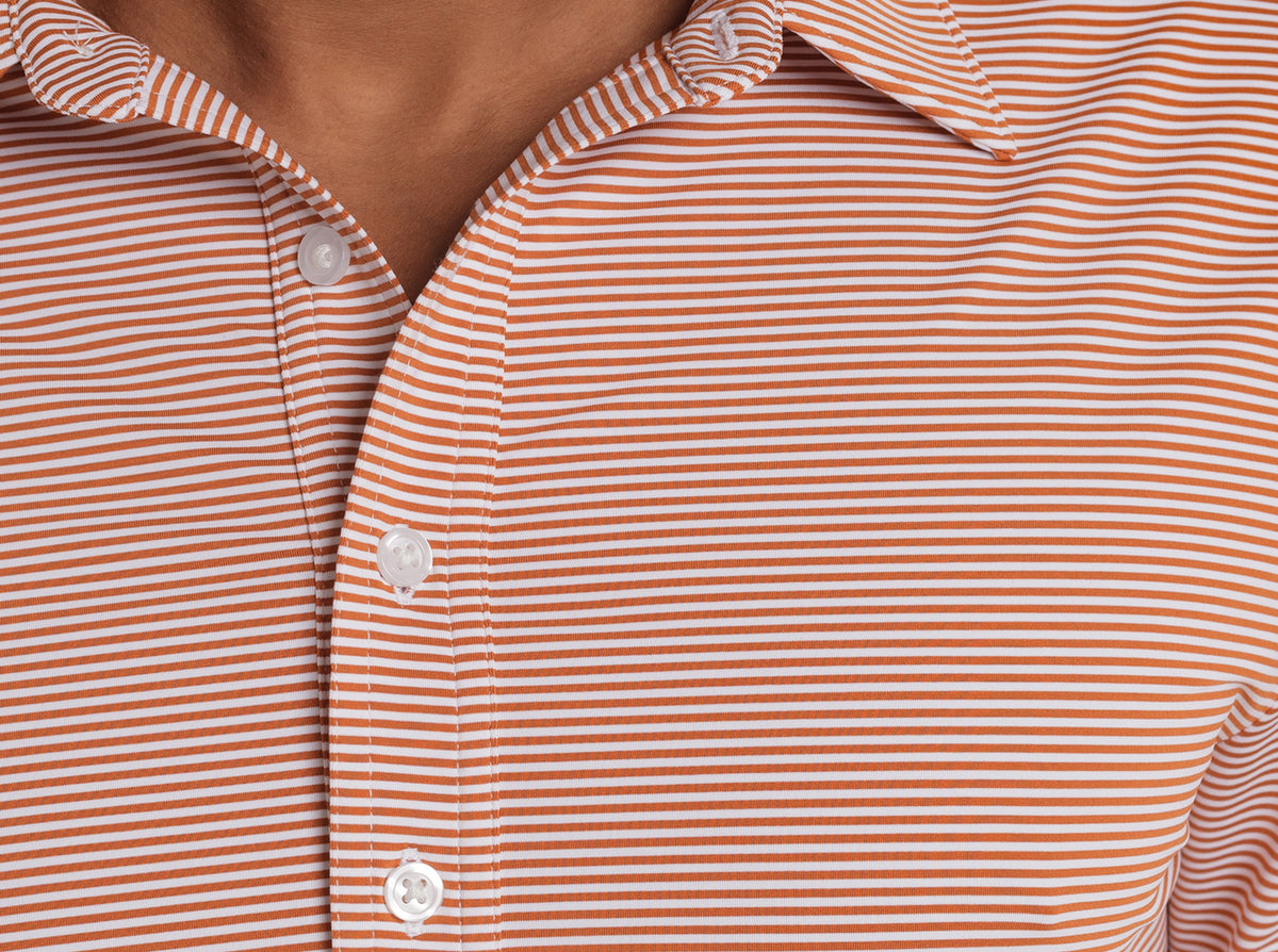 Criquet Performance Sport Range Polo in Hobby Stripe, Burnt Orange, studio photo